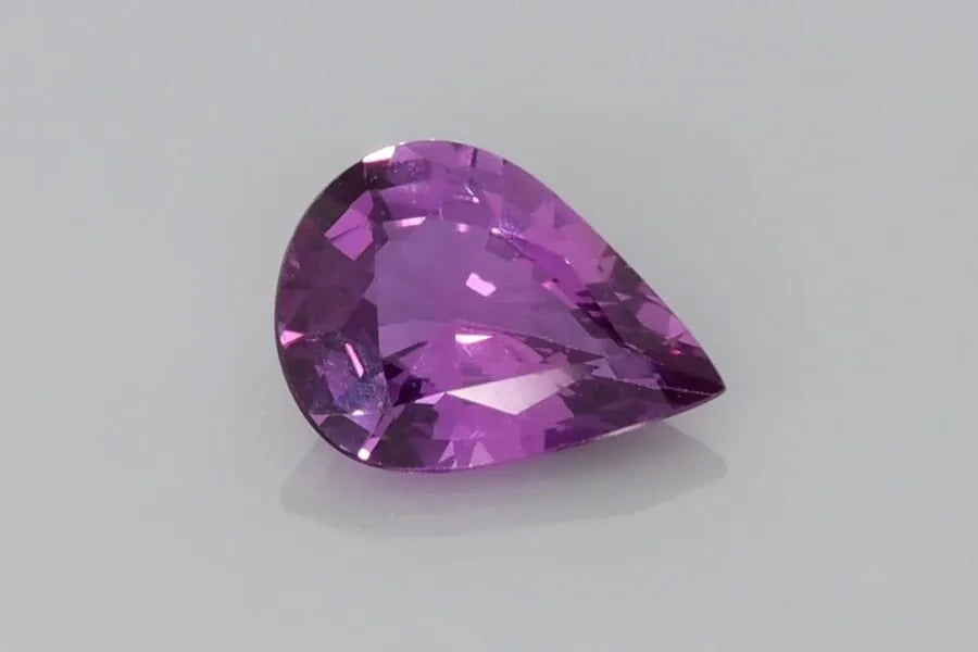 1.28 carat pear-shaped faceted purple sapphire.