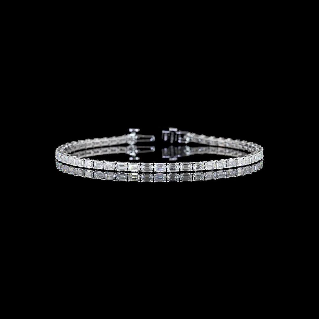 A 5.15ctw lab grown emerald cut diamond tennis bracelet in 14k white gold.