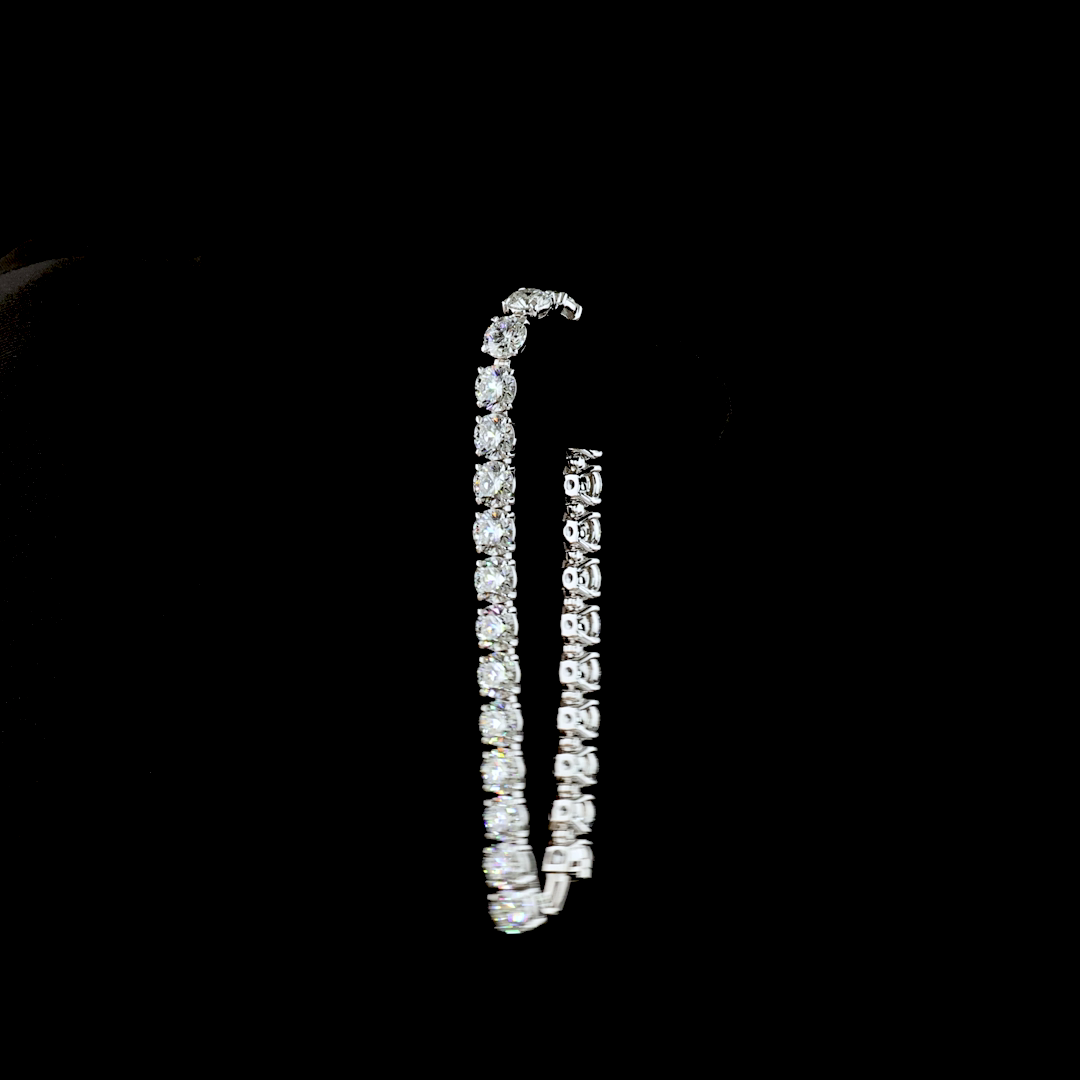 27.45ctw round cut lab grown diamond tennis bracelet in 14k white gold on a black background.