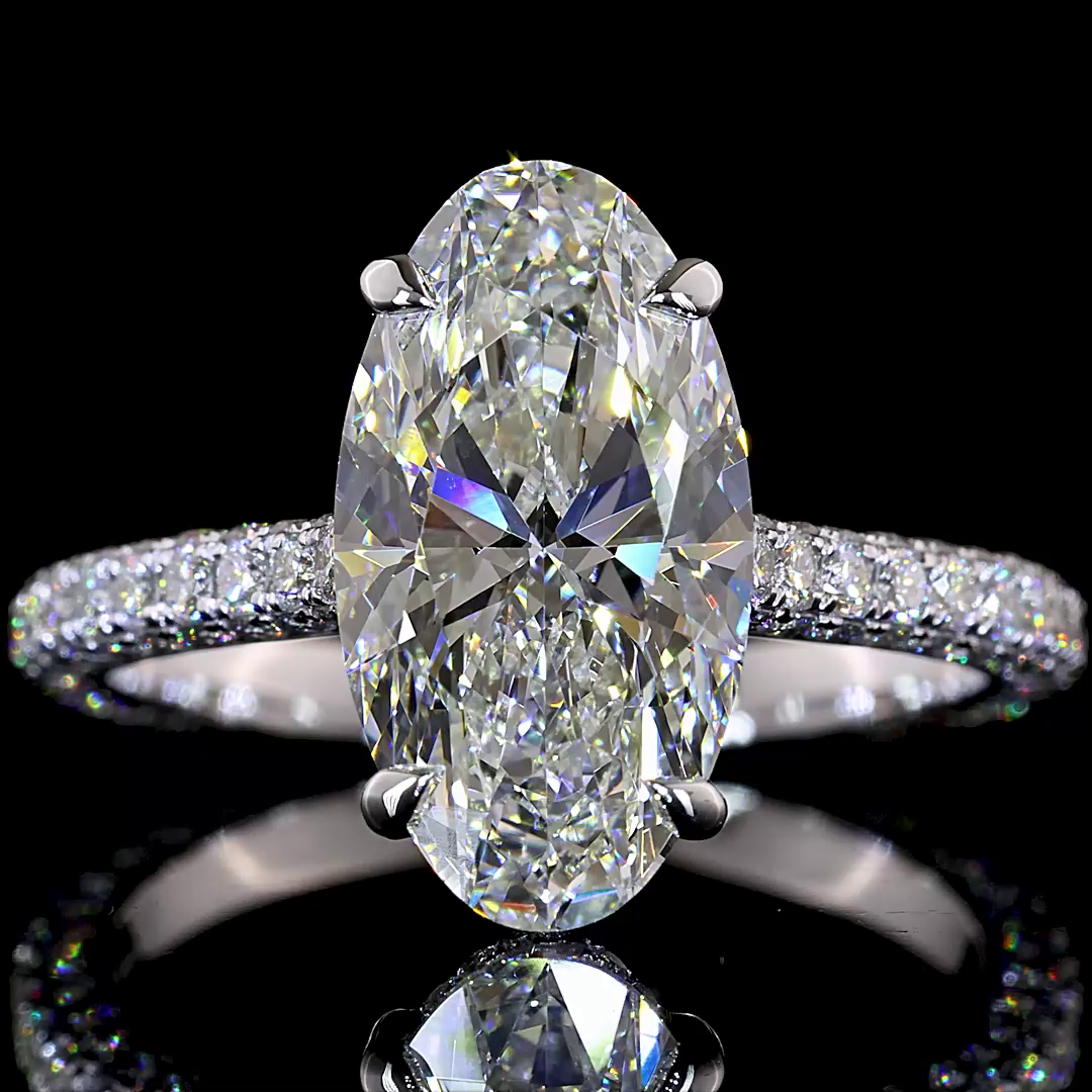 3.55ctw lab grown moval cut diamond engagement ring in 14k white gold with three-sided pavé band.