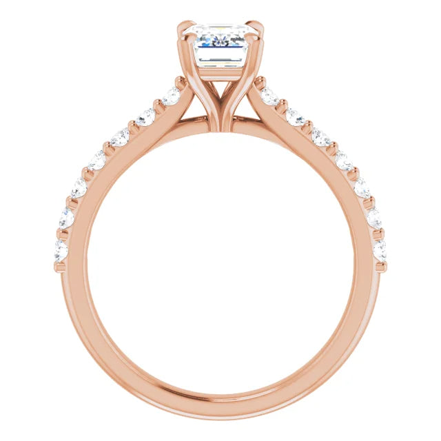 Emerald cut diamond engagement ring with pavé band.