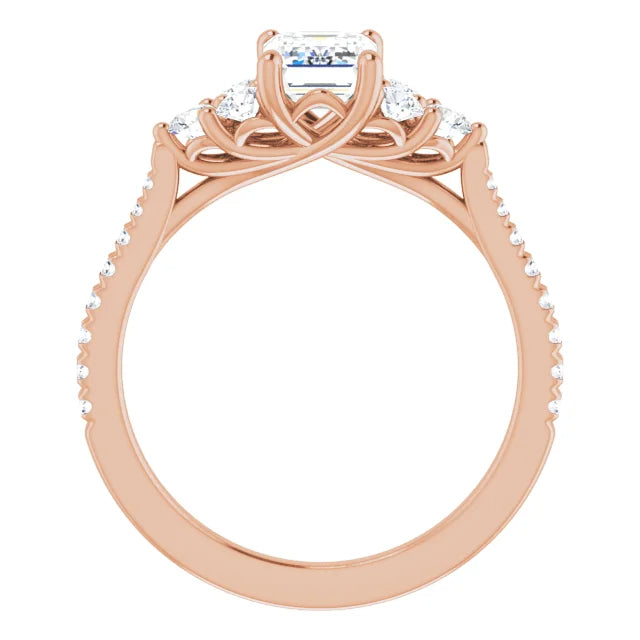 Rose gold engagement ring with an emerald cut center stone and pavé diamond band.