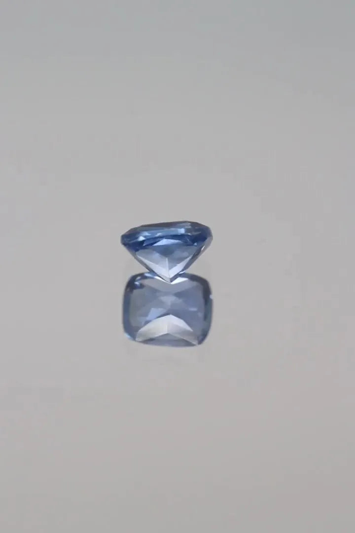 0.88ct cushion cut faceted blue sapphire with eye clean clarity.