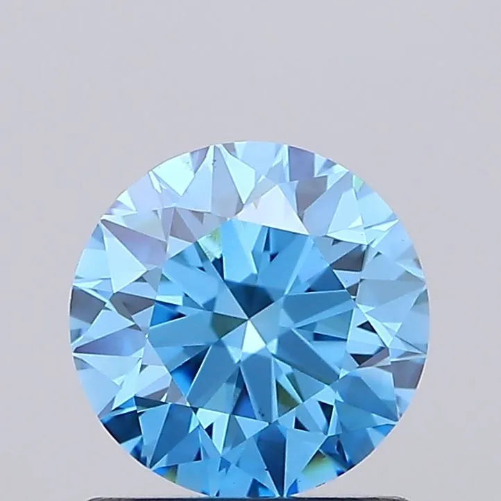 A 1.02 carat round lab grown diamond with fancy vivid blue color and VS1 clarity.