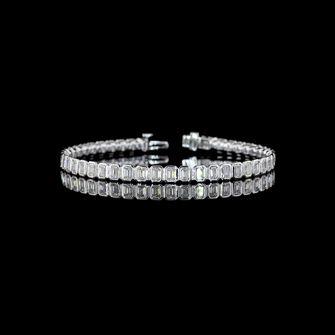 7.28ctw lab grown emerald cut diamond tennis bracelet in a 14k white gold bezel setting.