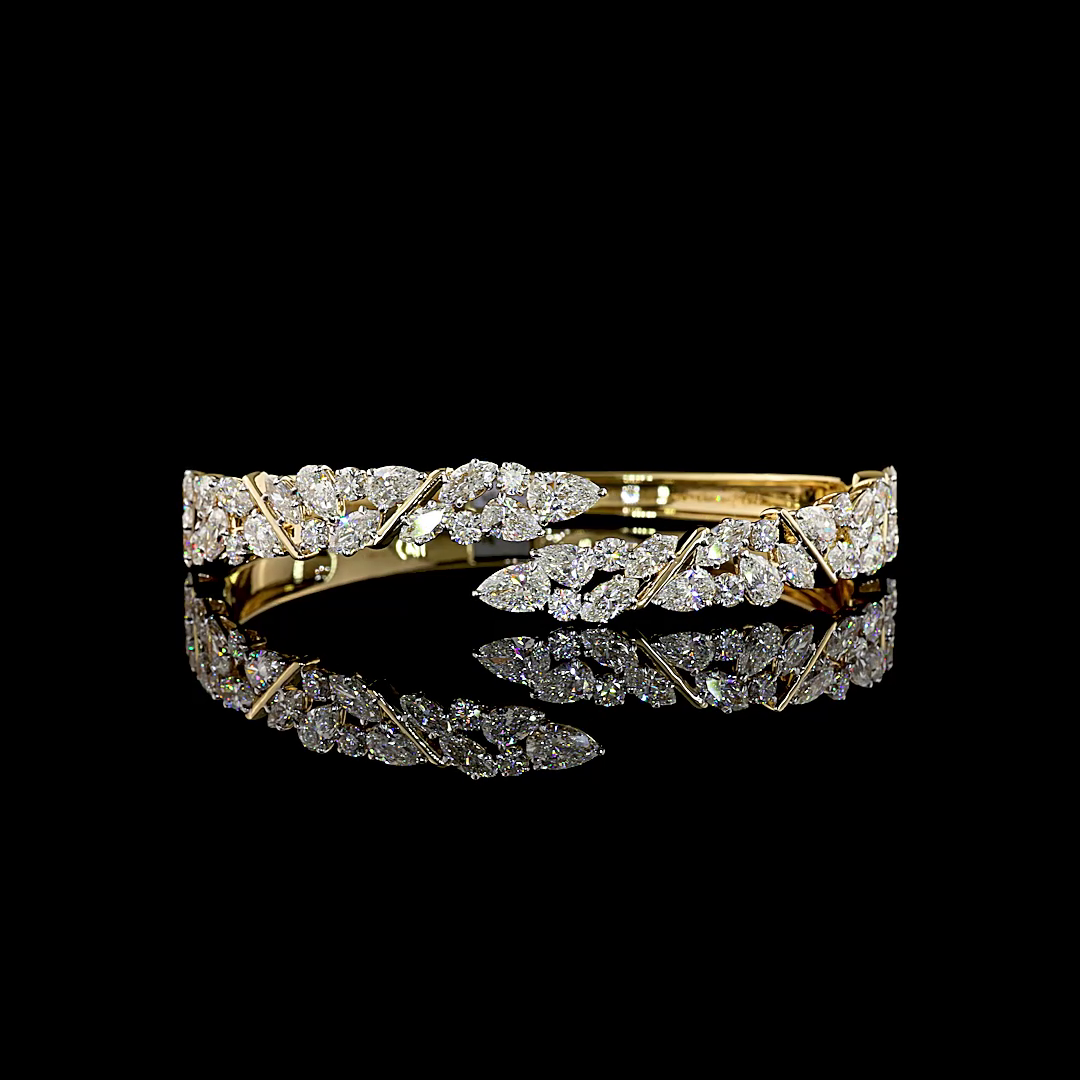 8.09ctw lab grown mixed shape diamond hinged cuff bracelet in 14k yellow gold on a black background.