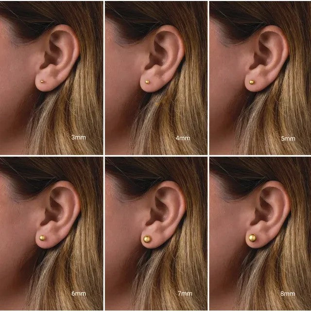Round ball stud earrings in various sizes shown on an ear.