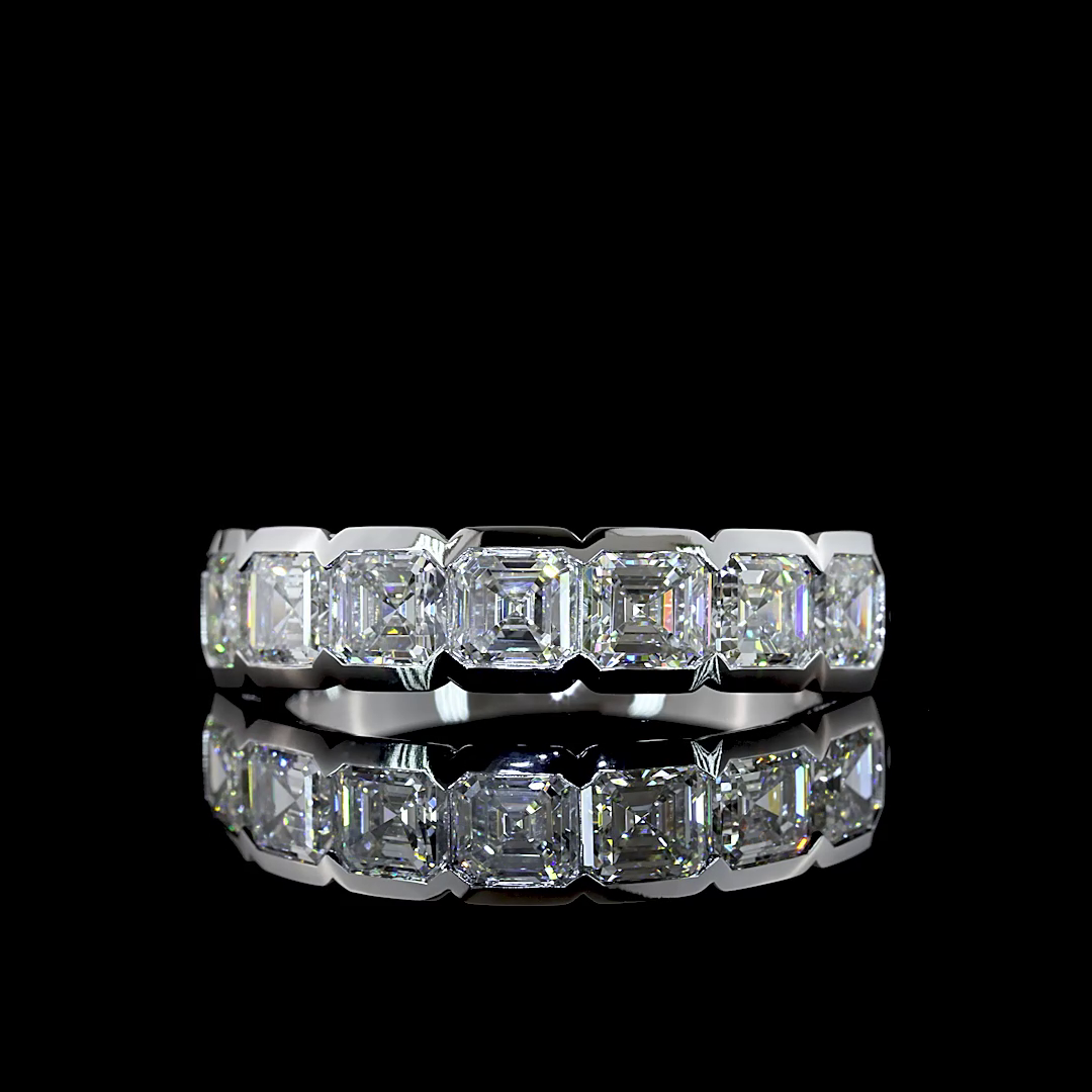 A seven-stone lab grown asscher cut diamond ring in a white gold semi-bezel setting.
