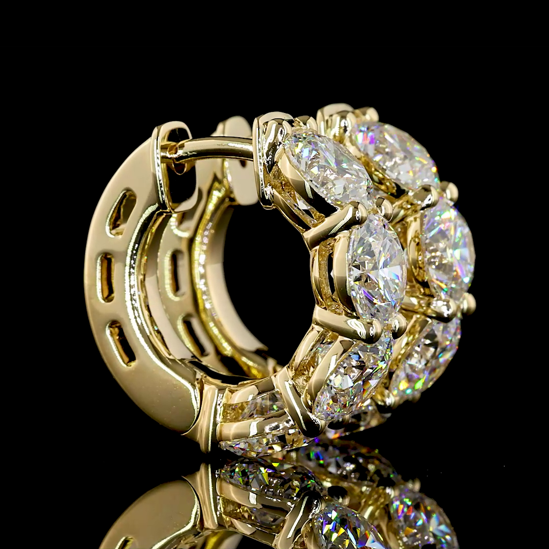 A pair of 14k yellow gold huggie earrings featuring two rows of round lab grown diamonds.