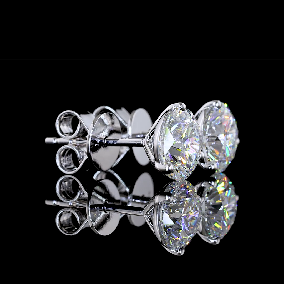 2.07ctw lab grown round diamond martini stud earrings in 14k white gold on a reflective surface.