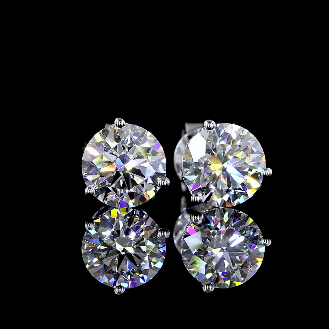 2.07ctw lab grown round diamond martini stud earrings in 14k white gold on a reflective surface.