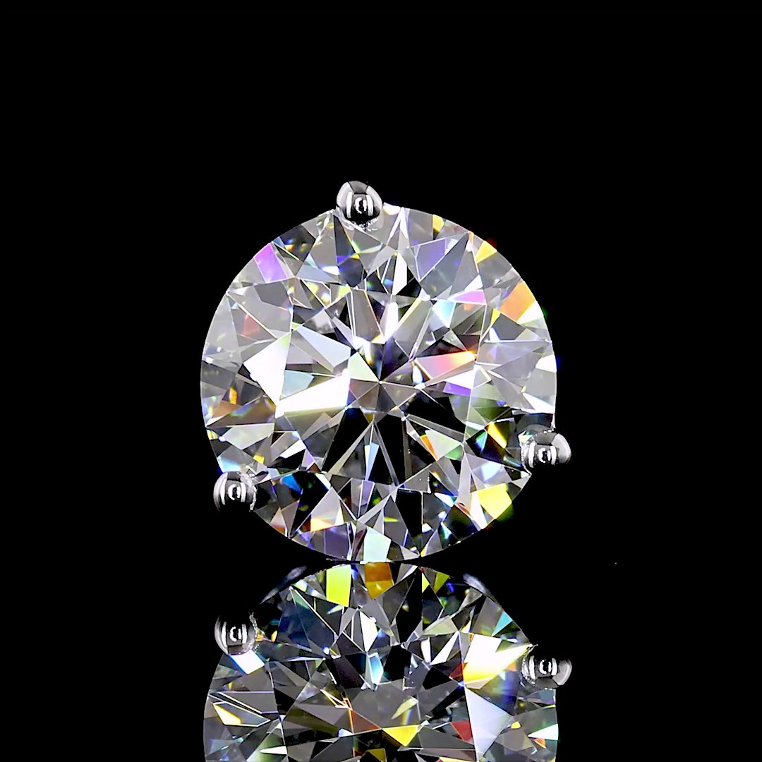 Lab grown round diamond martini stud earring in 14k white gold on a black reflective surface.