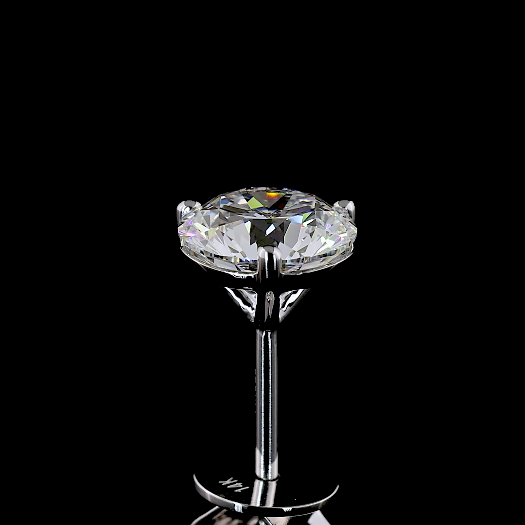 A single lab-grown round diamond martini stud earring in 14k white gold on a black background.