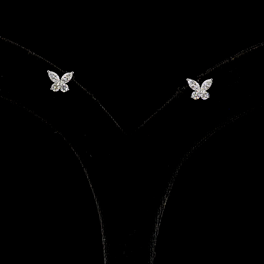 0.67ctw lab grown diamond butterfly stud earrings in 14k white gold on a black display stand.