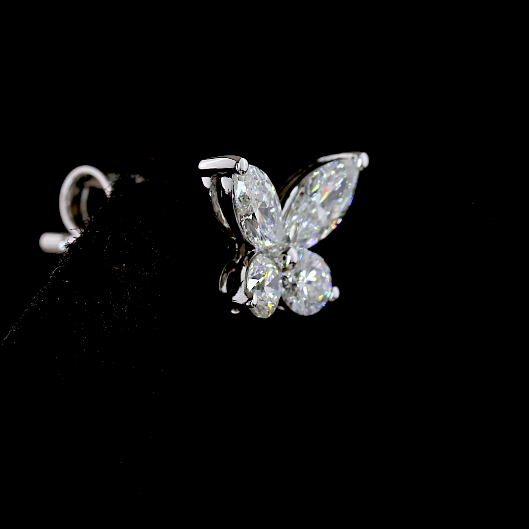 0.67ctw lab grown diamond butterfly stud earring in 14k white gold on a black background.