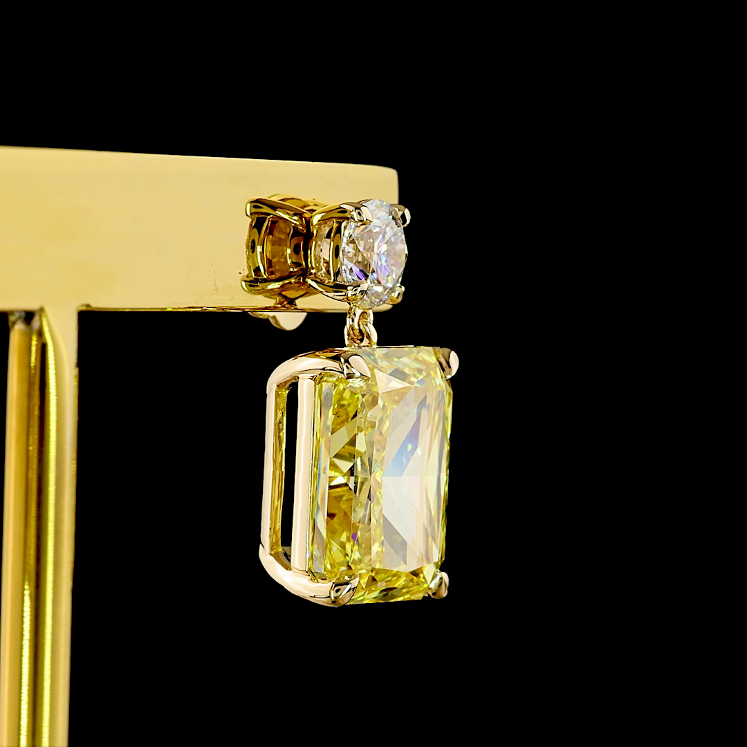 14k yellow gold earring with a round white diamond above a large radiant-cut yellow lab diamond.