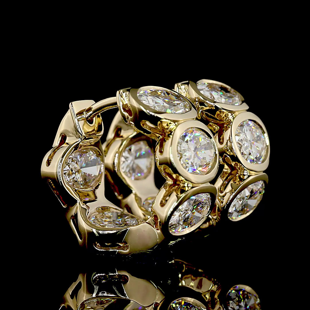 5.38ctw lab grown oval diamond huggie earrings in 14k yellow gold with bezel settings.