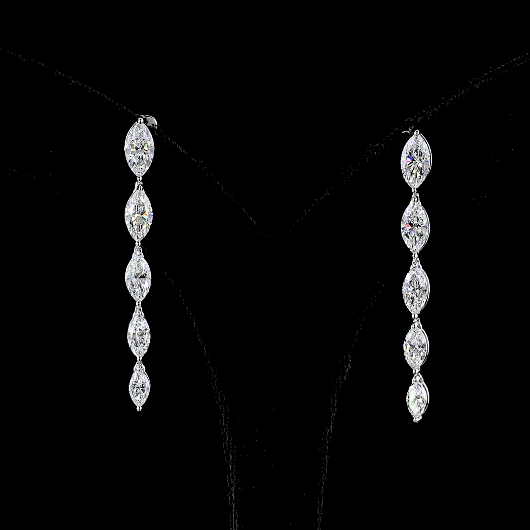 Lab grown marquise diamond drop earrings in 14k white gold against a black background.