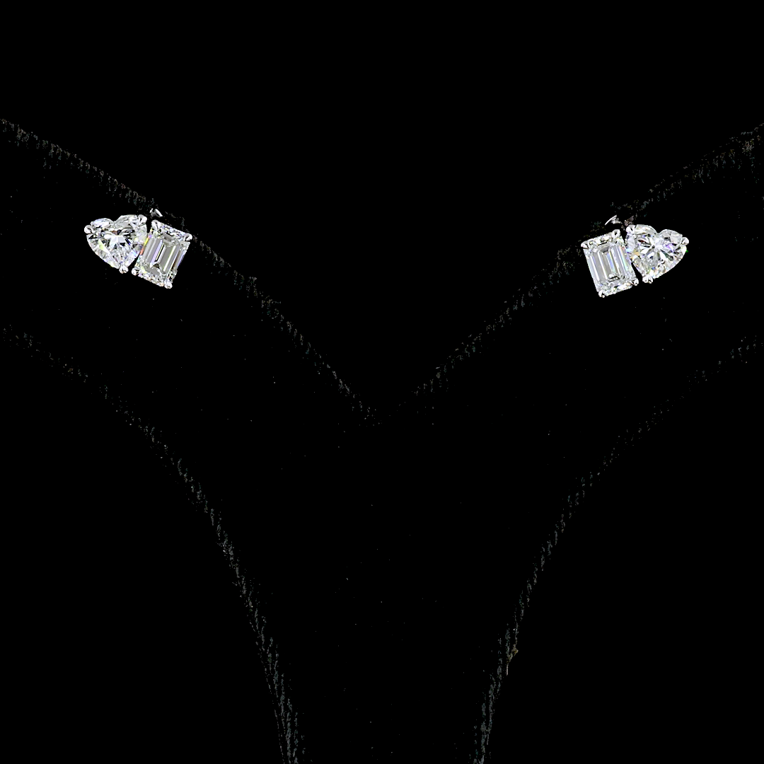 1.53ctw lab grown heart and emerald cut diamond stud earrings set in 14k white gold.