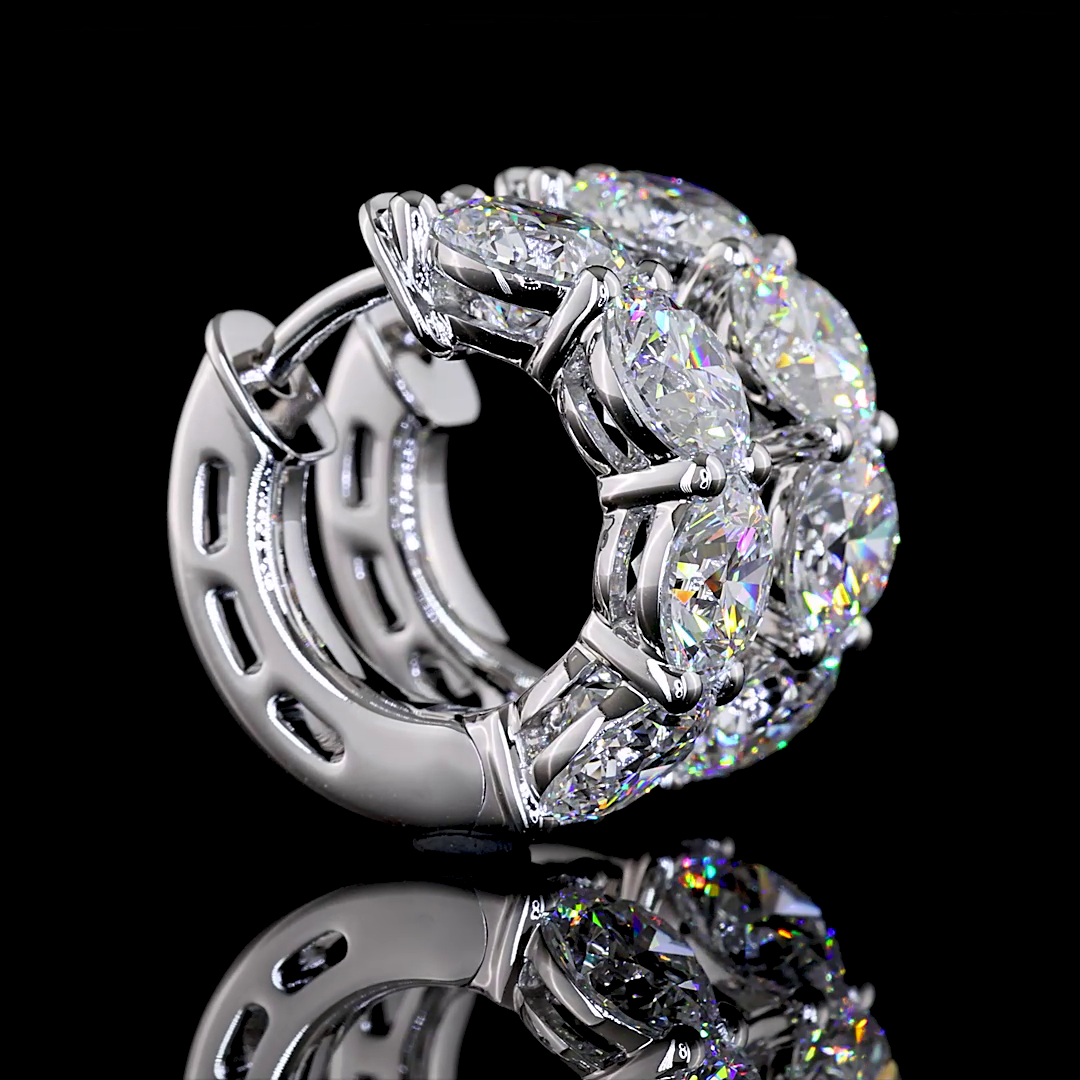 A pair of 14k white gold huggie earrings featuring 4.99 carats of lab grown round diamonds.