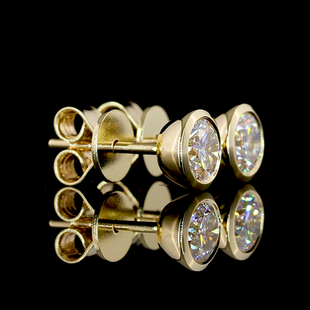 0.99ctw lab grown round diamond solitaire stud earrings in 14k yellow gold.