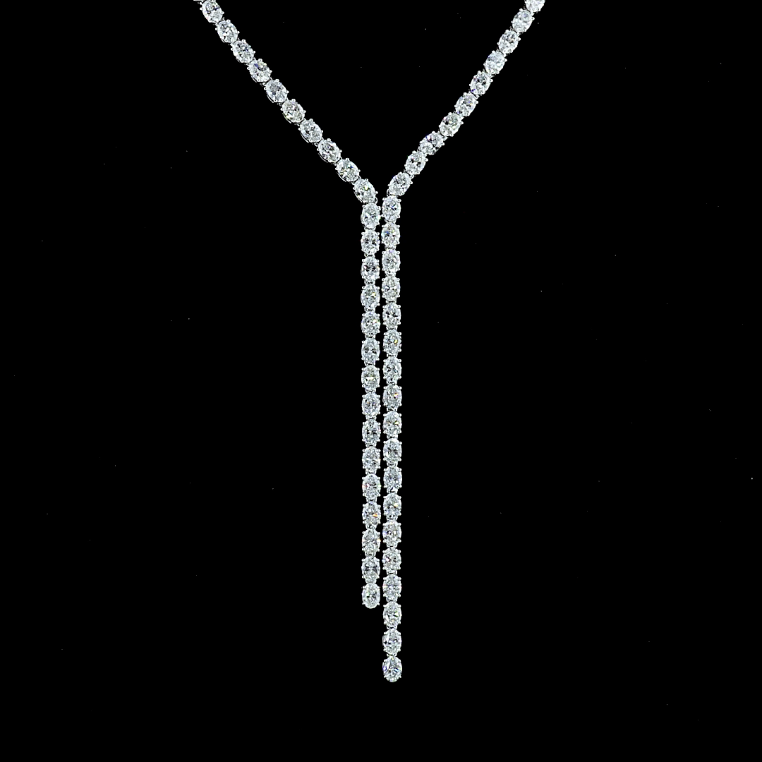 13.89ctw oval cut lab grown diamond lariat necklace in 14k white gold on a black background.