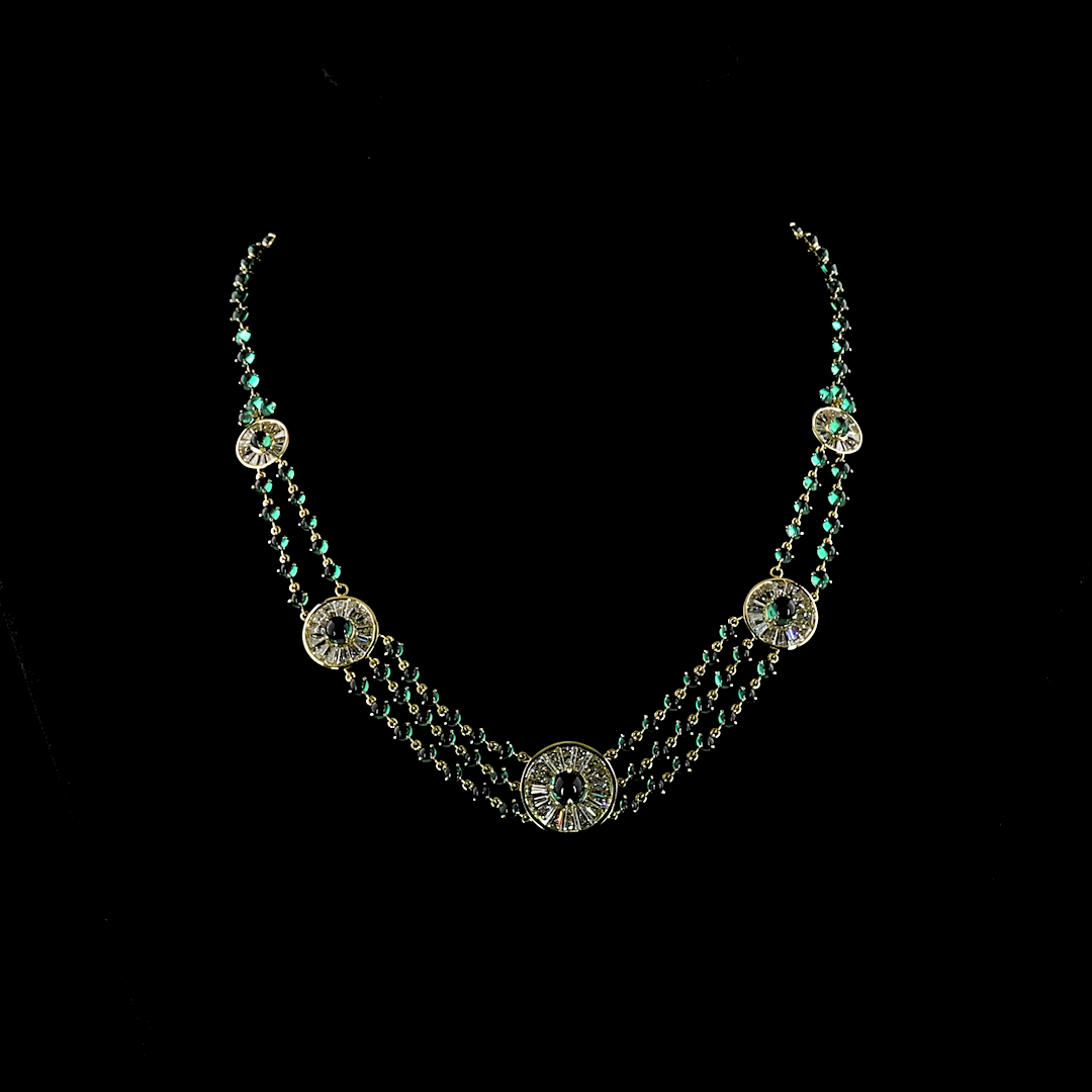 14k yellow gold necklace with five diamond medallions and three strands of lab grown emeralds.