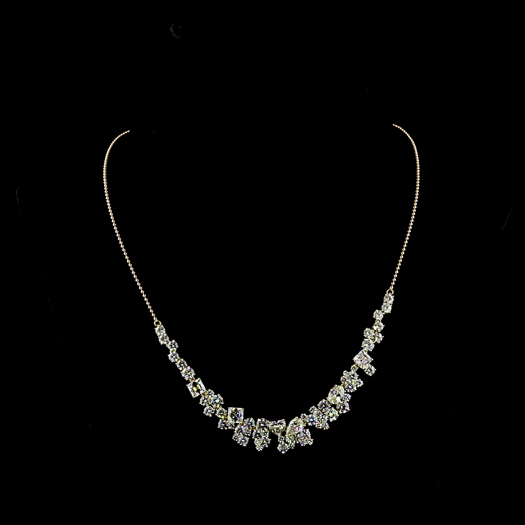 14k yellow gold necklace with 18.26ctw of mixed-shape lab grown diamonds on a black background.