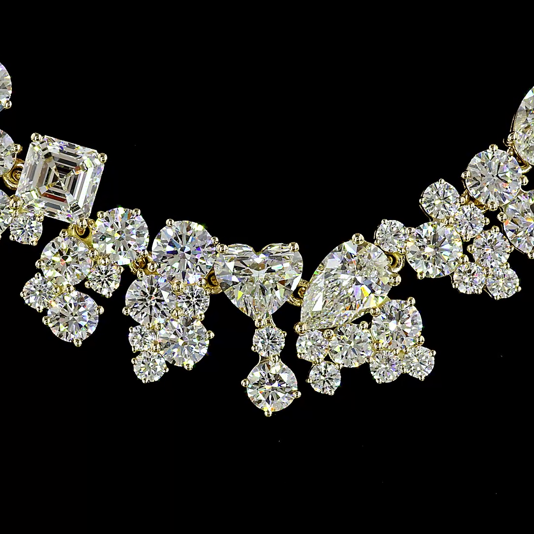 14k yellow gold necklace featuring 18.26ctw of mixed-shape lab grown diamonds on a black background.