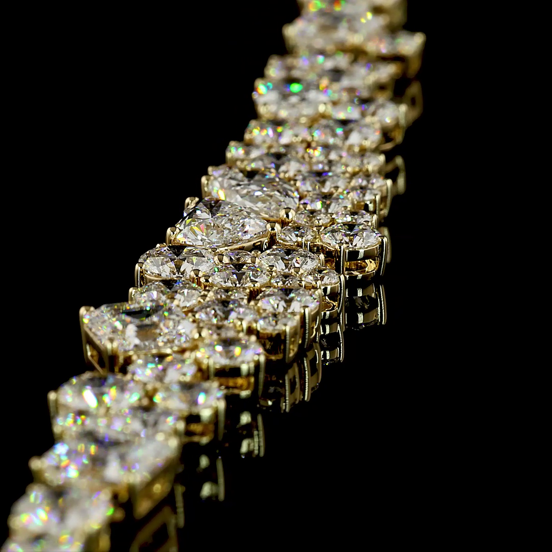 Close-up of a 14k yellow gold necklace featuring mixed-shape lab grown diamonds on a black surface.