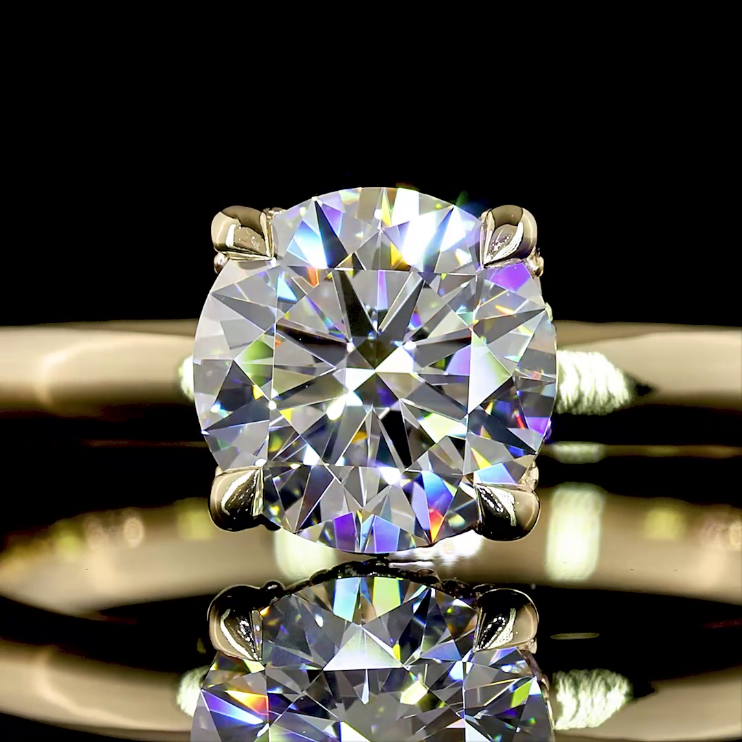 Close-up of a 1.13ctw round brilliant lab grown diamond solitaire ring in 14k yellow gold.