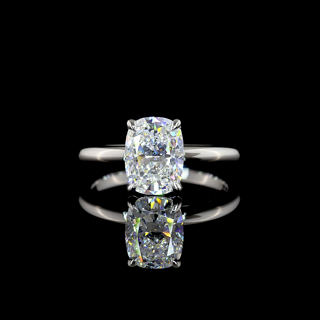 2.07ct lab grown cushion diamond solitaire engagement ring in 14k white gold on a black background.