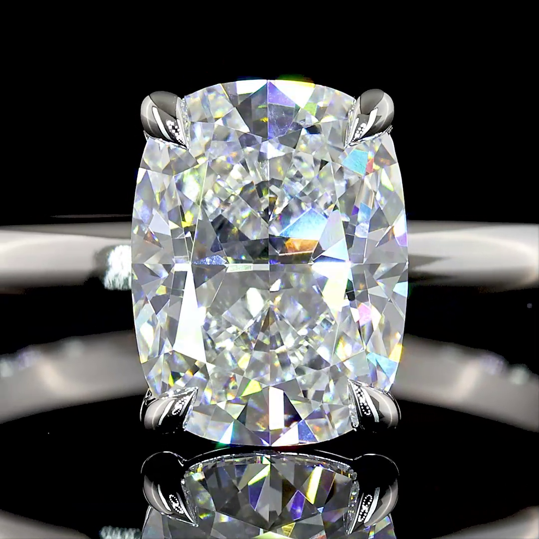 Lab grown cushion cut diamond solitaire engagement ring in a 14k white gold setting.
