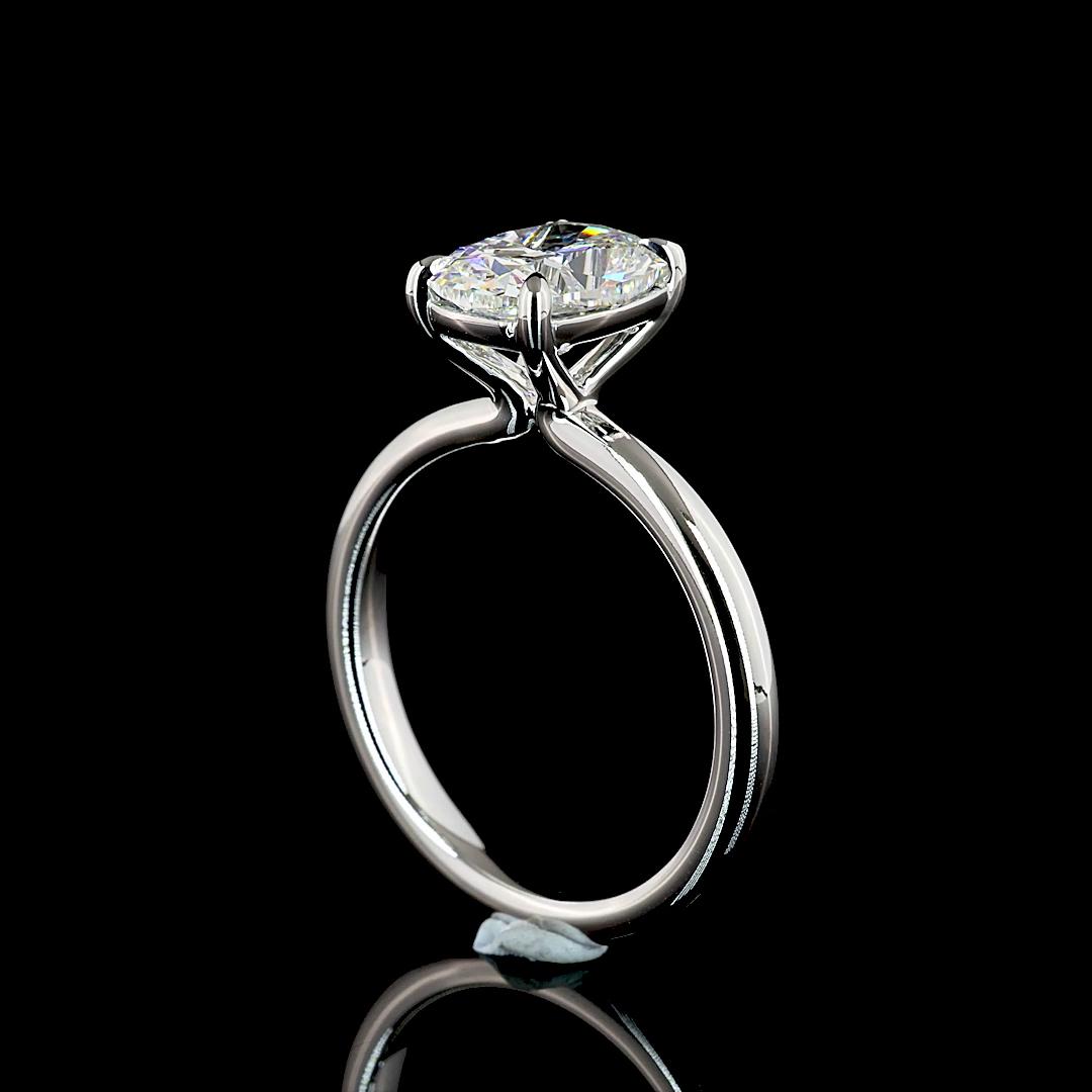2.07ct lab grown cushion diamond solitaire engagement ring in 14k white gold on a black background.