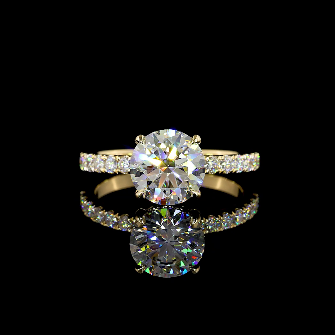 A 14k yellow gold engagement ring with a large round diamond and smaller diamonds on the band.