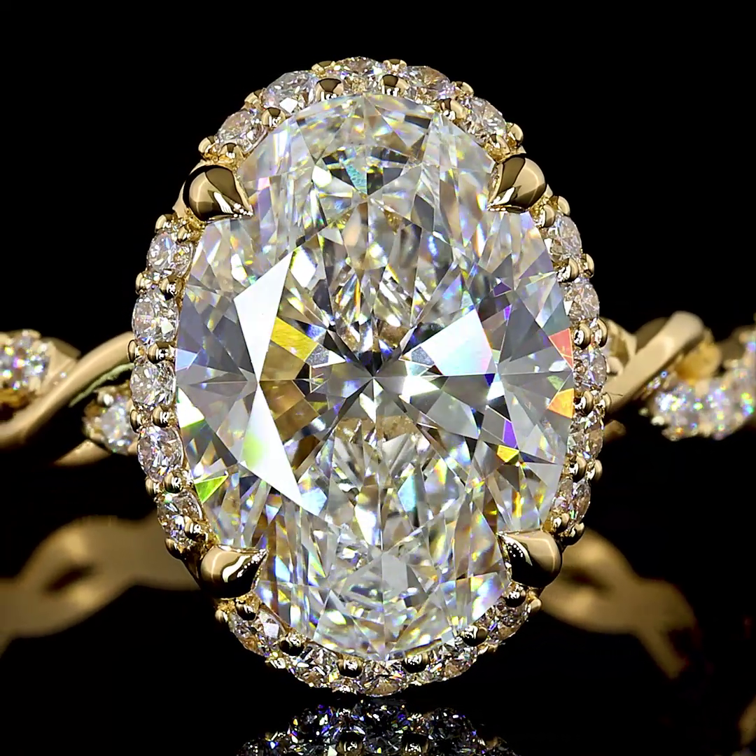 3.55ctw lab grown oval diamond engagement ring in 18k yellow gold with a halo and twisted band.