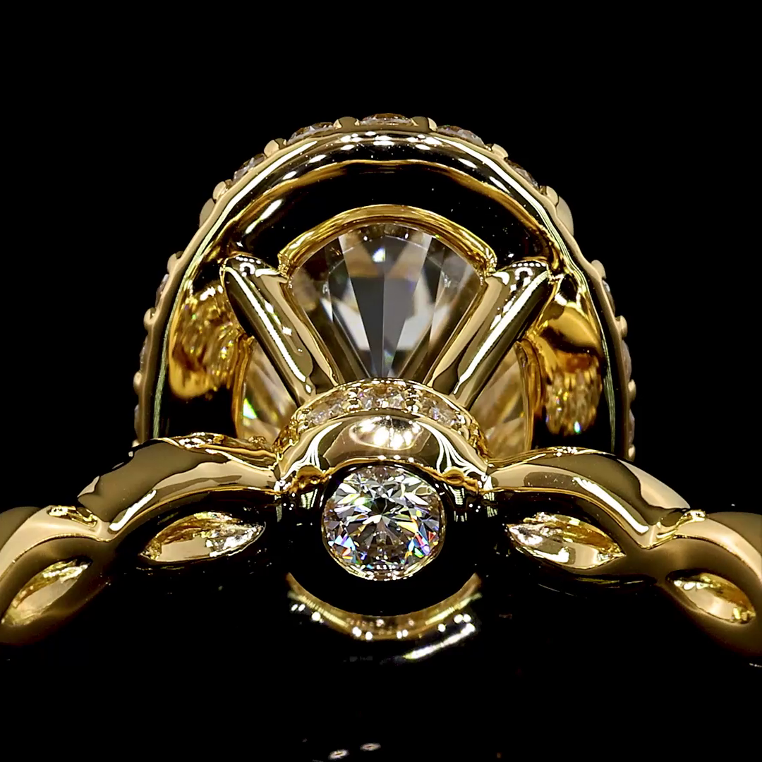 Side view of an 18k yellow gold ring showing a hidden diamond under the oval center stone setting.