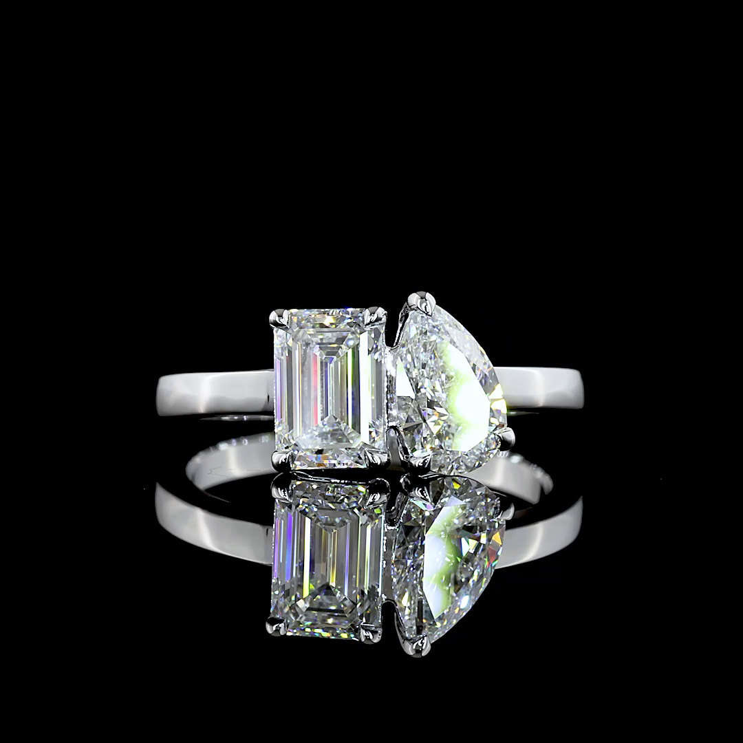 Lab grown Toi et Moi engagement ring with emerald and pear cut diamonds in 14k white gold.