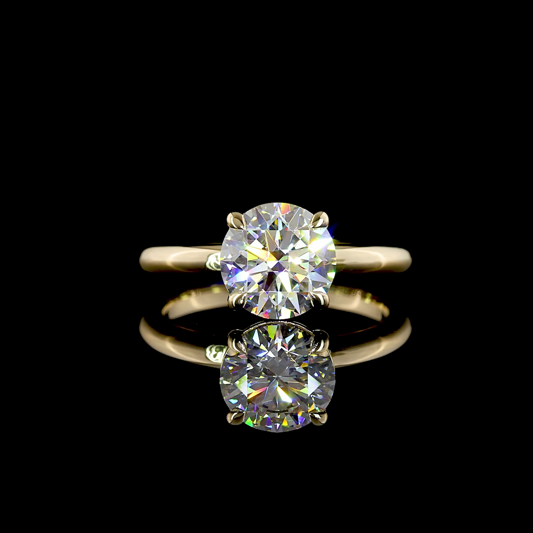 A 2.14ct round lab grown diamond solitaire engagement ring in 14k yellow gold.