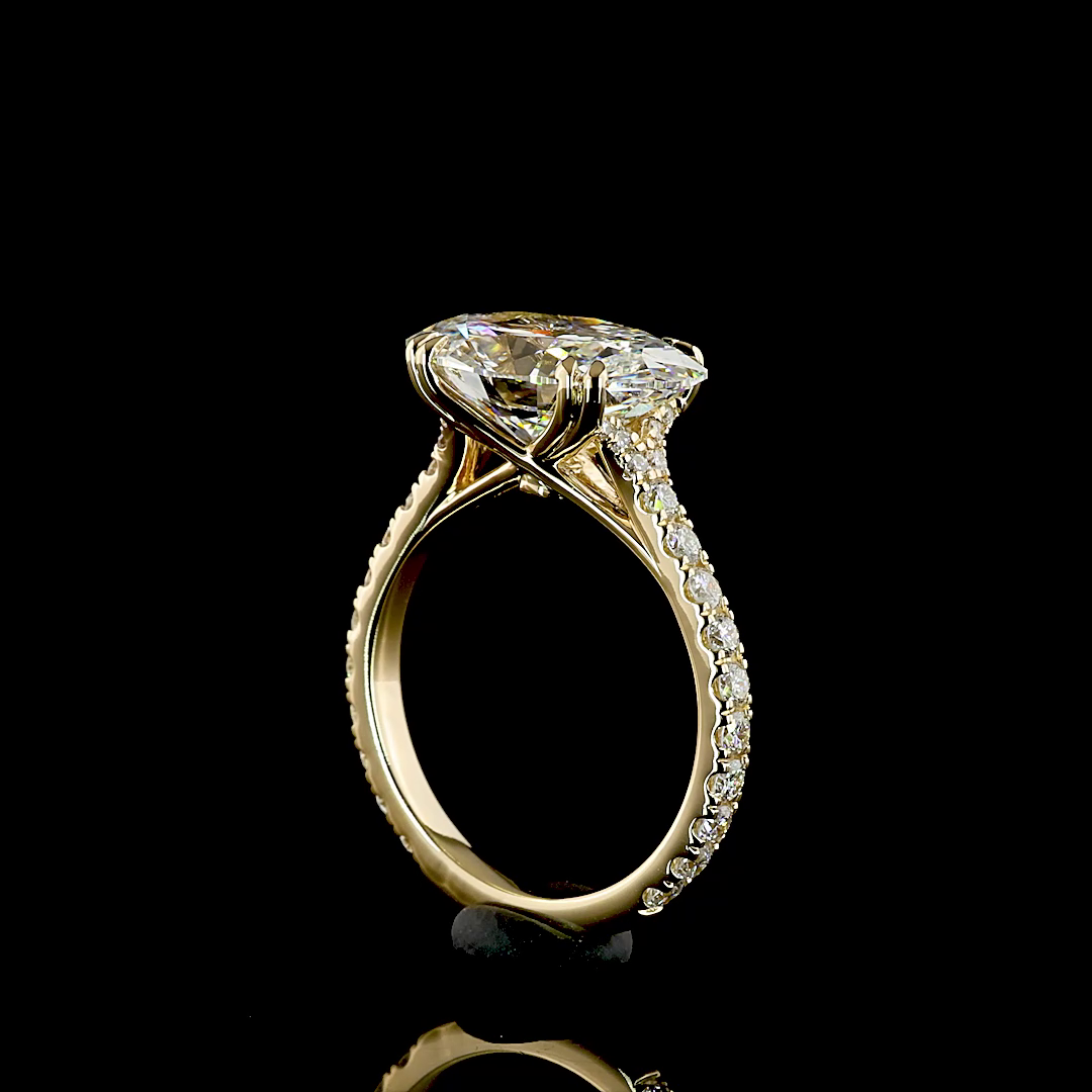 Side view of a 4.89ctw oval lab grown diamond engagement ring in 14k yellow gold with pavé band.