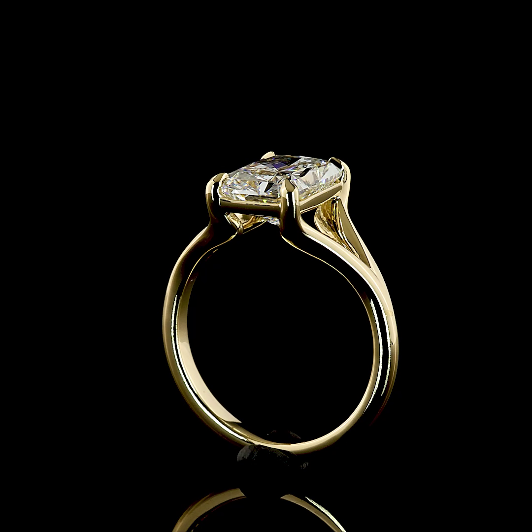 3.12ct lab grown radiant cut diamond engagement ring in 14k yellow gold with a split shank setting.