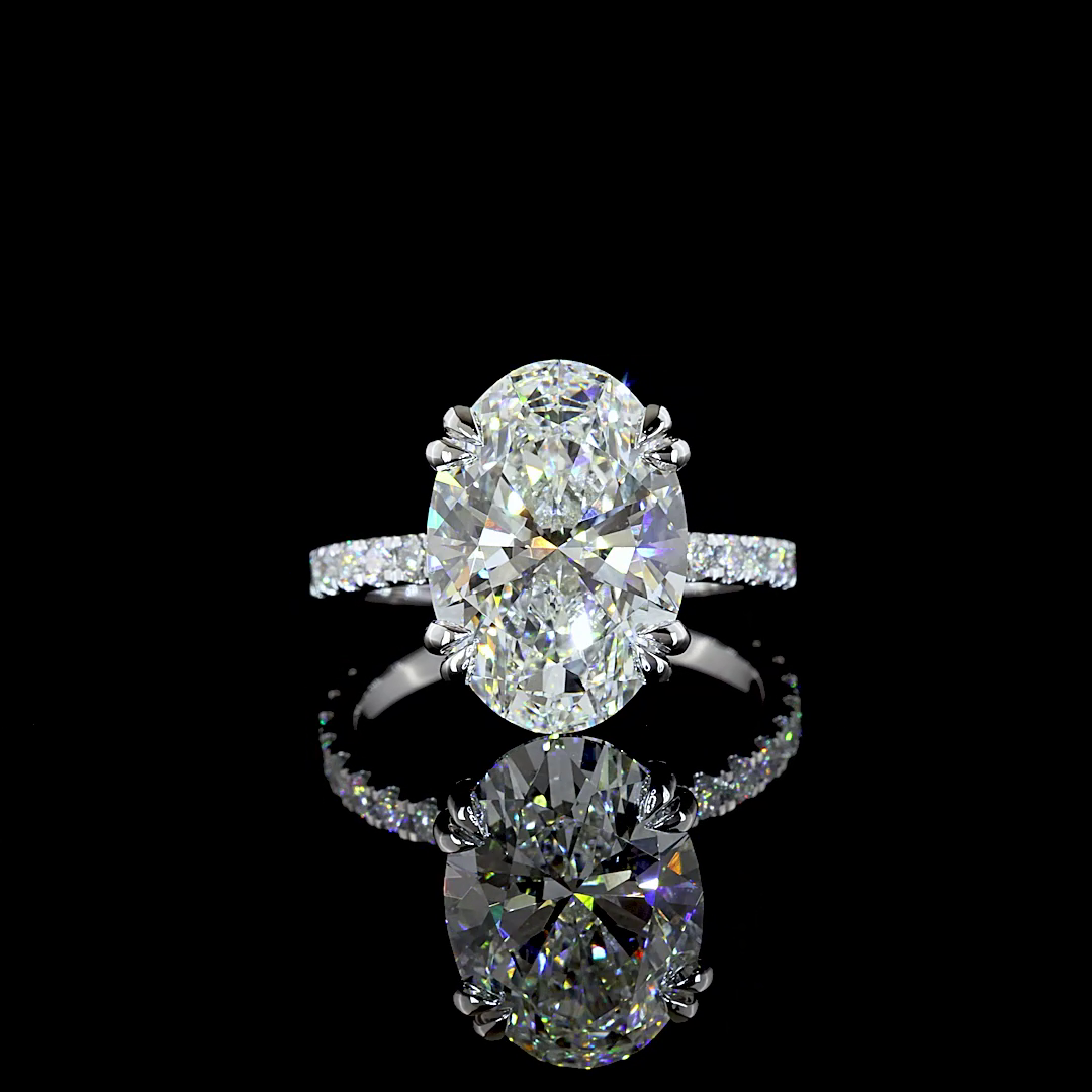 6.79ctw lab grown oval diamond engagement ring in 14k white gold with a diamond-set band.