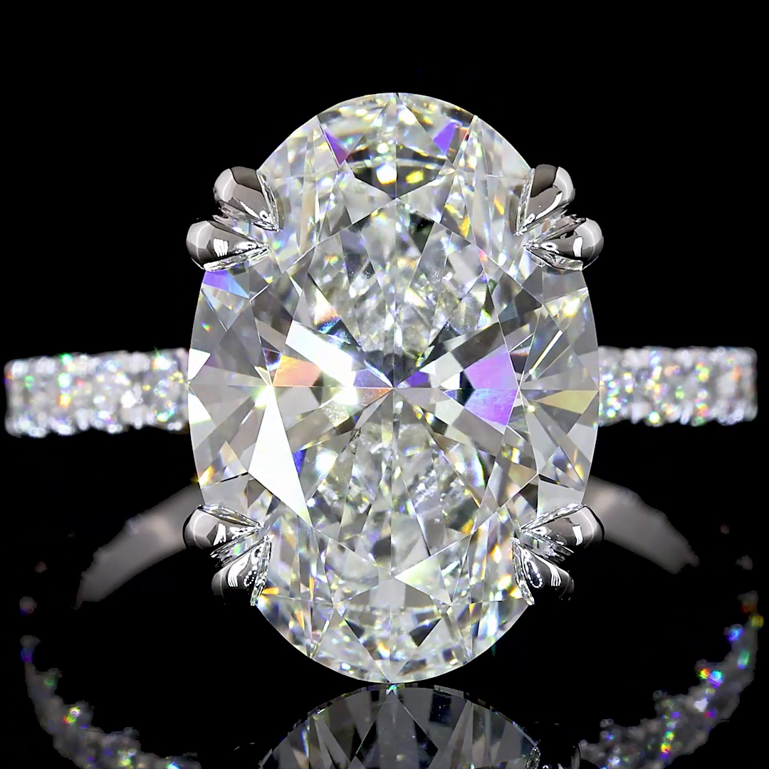 6.79ctw lab grown oval diamond engagement ring in 14k white gold with a pavé band.