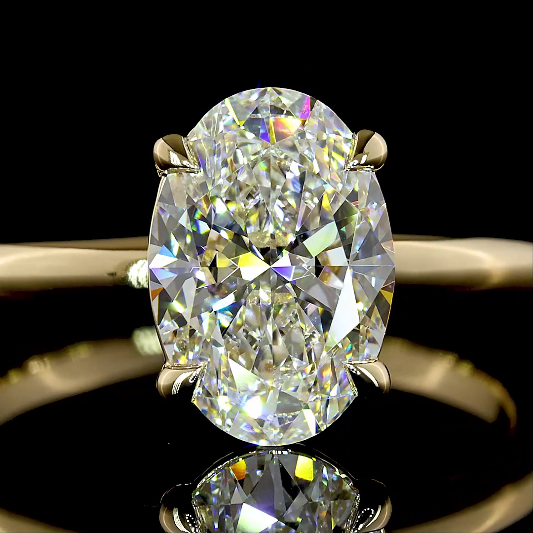 2.12ct lab grown oval diamond solitaire engagement ring in 14k yellow gold.