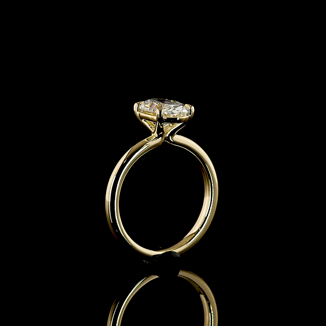 2.12ct lab grown oval diamond solitaire engagement ring in 14k yellow gold on a black background.