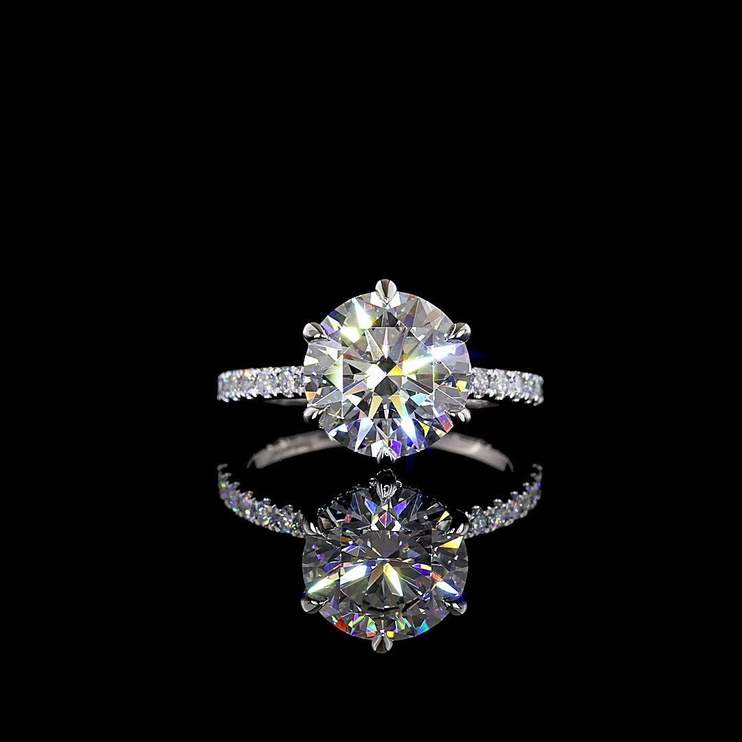 3.36ctw lab grown round diamond engagement ring in a six-prong platinum setting with a diamond band.