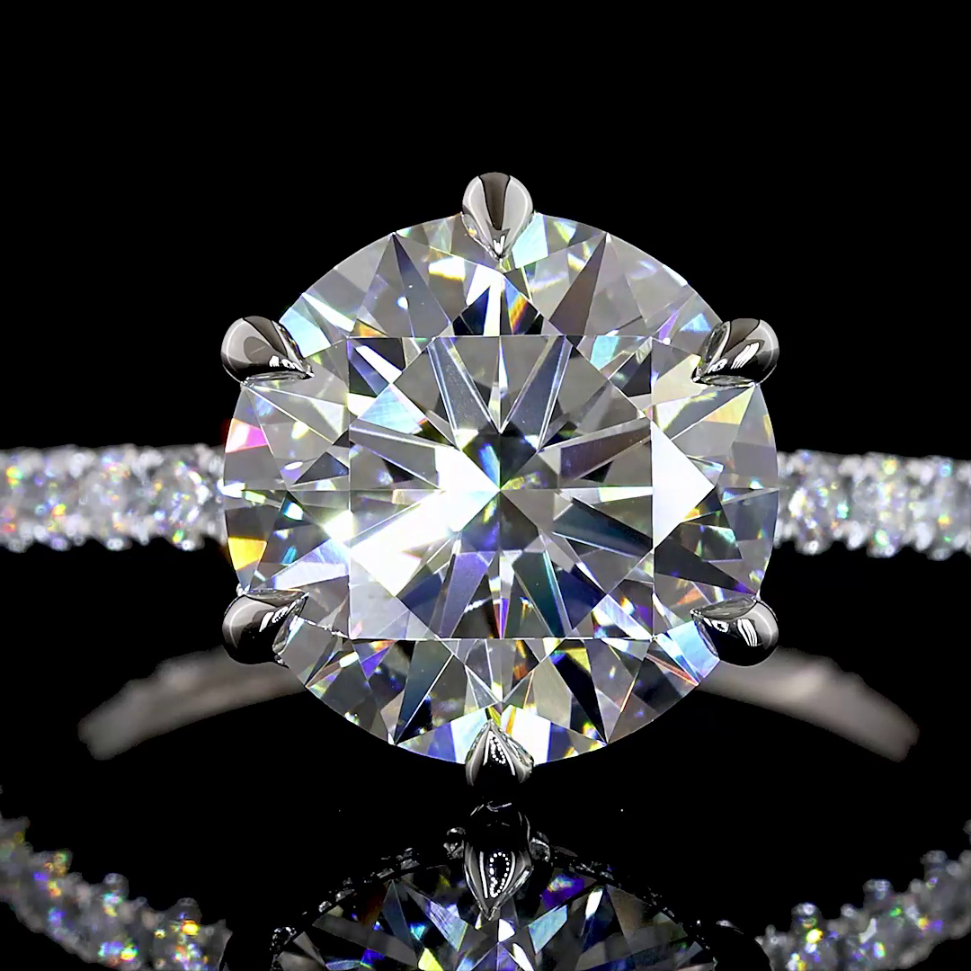 Close-up of a 3.36ctw lab grown round diamond engagement ring in a six-prong platinum setting.