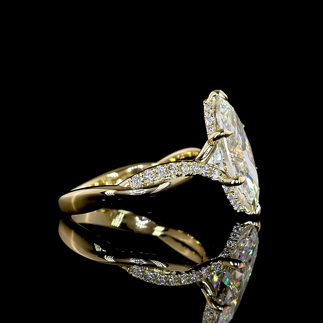 Side view of a 14K yellow gold marquise engagement ring with a hidden halo and twisted diamond band.