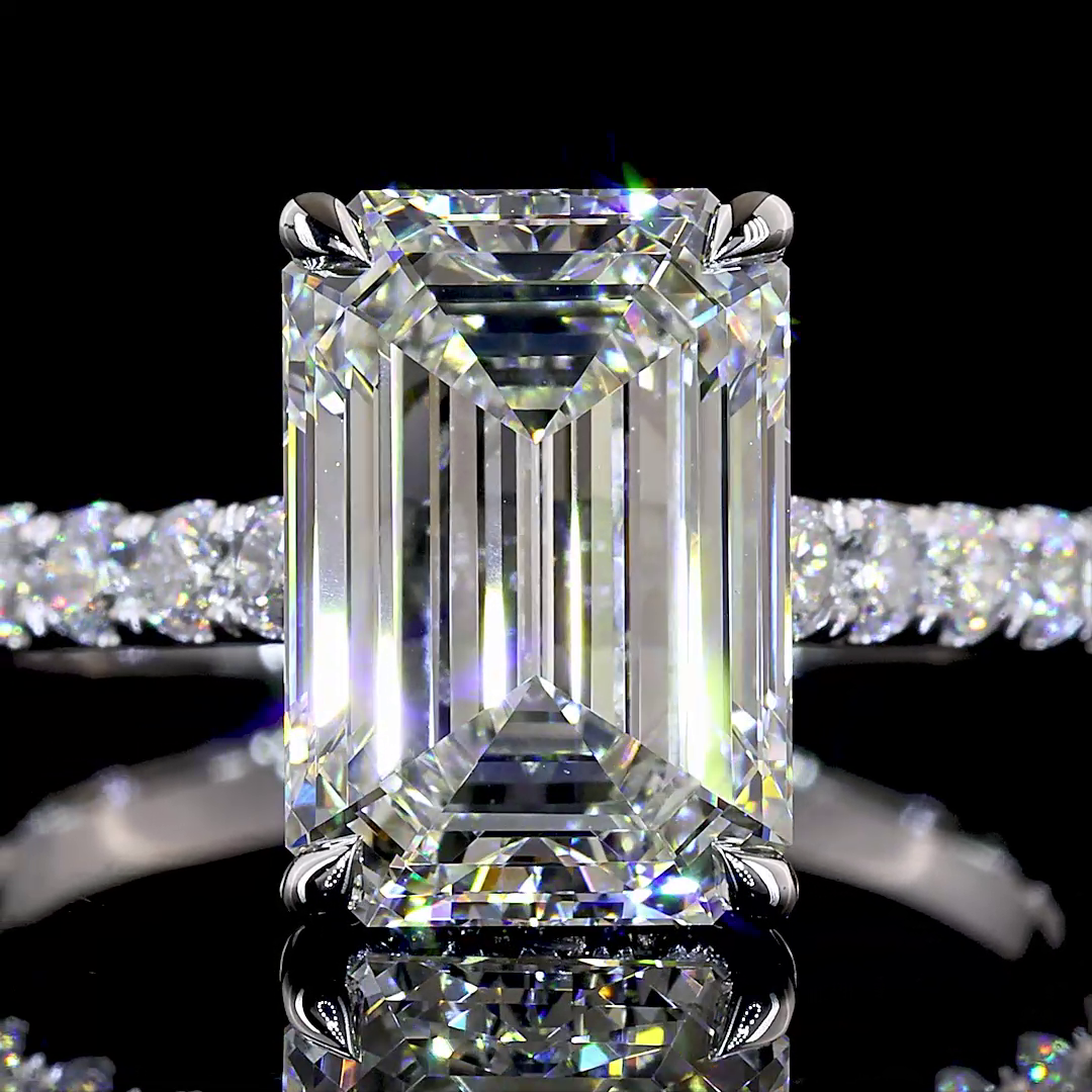 3.93ctw emerald cut lab grown diamond engagement ring in 14K white gold with a pavé band.