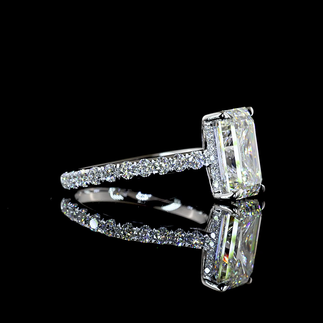 Side view of a 3.93ctw emerald cut lab grown diamond engagement ring in 14K white gold.